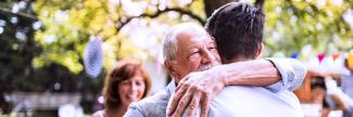 Man hugging his elderly father